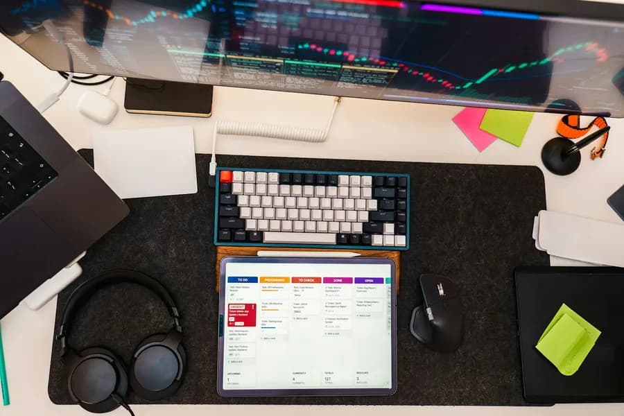 Mechanical keyboard, tablet and monitor on a desk